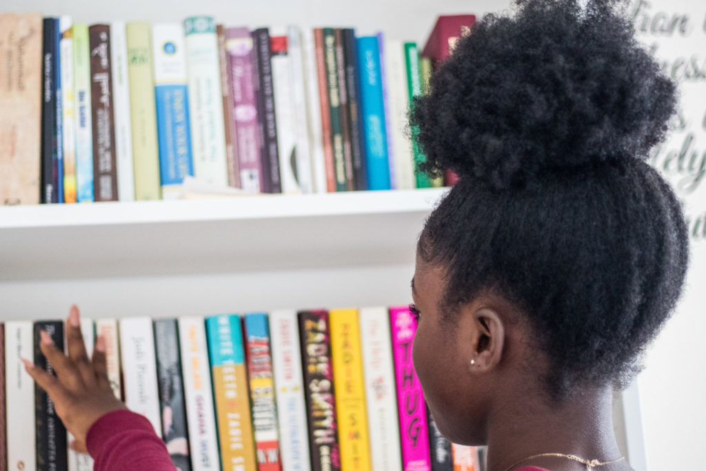 A girl choosing a self help book to read.