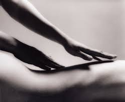 Massage Therapist hands on body.