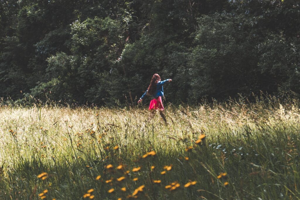 woman standing on green grass field ex