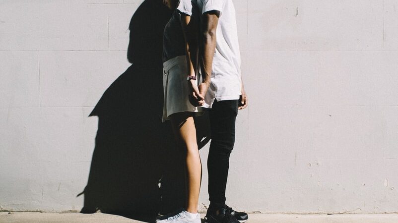 couple leaning on wall